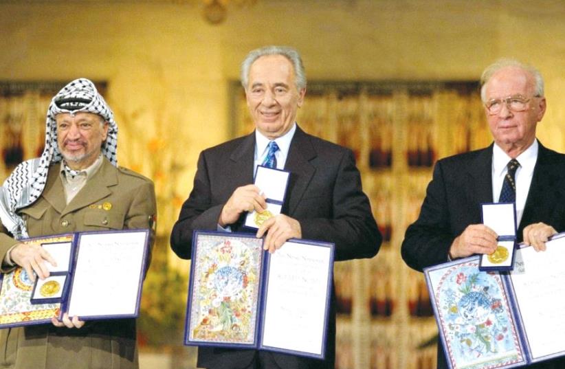 PERES receives the Nobel Peace Prize in Oslo, Norway, in 1994 alongside Yitzhak Rabin and Yasser Arafat. (photo credit: GPO)