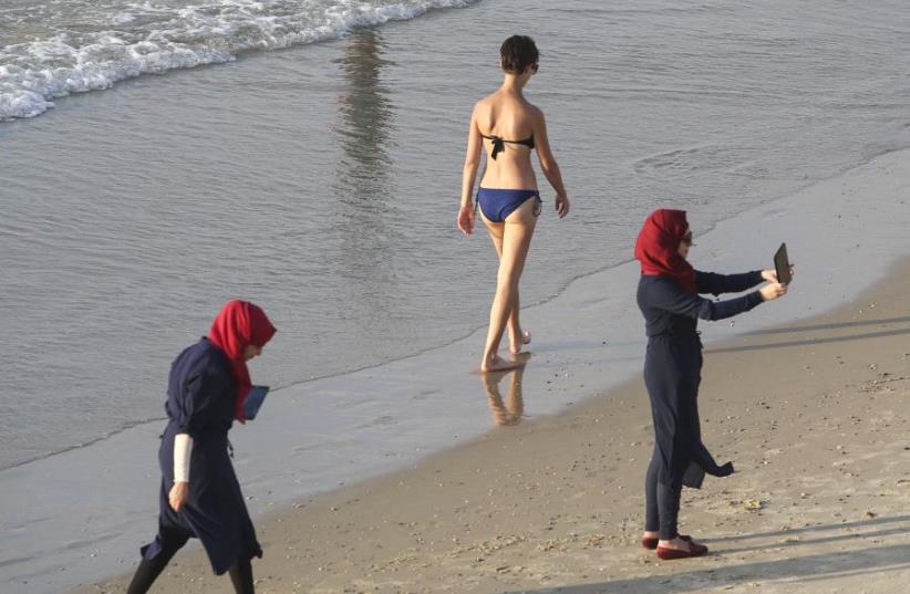Arab women wearing burkinis at a beach in Tel Aviv (photo credit: MARC ISRAEL SELLEM)