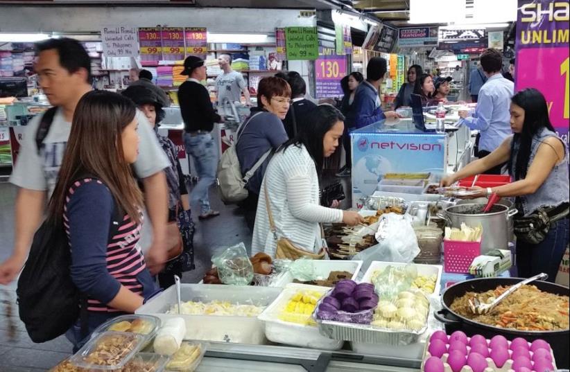 Friday afternoon in the Filipino shuk, outside Evelyn’s Market, brings customers from all over Tel Aviv and Israel (photo credit: AVERY ROBINSON)
