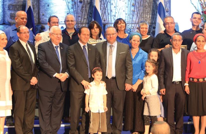 THE FRAENKEL, Shaer and Yifrach families, with President Reuven Rivlin and Jerusalem Mayor Nir Barkat at the Jerusalem Unity Prize award ceremony. (photo credit: SASSON TIRAM)