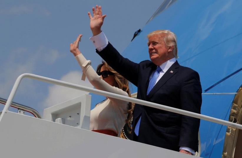 US President Donald Trump and first lady Melania Trump board Air Force One for his first international trip as president, including stops in Saudi Arabia, Israel, the Vatican, Brussels and at the G7 summit in Sicily, from Joint Base Andrews, Maryland, US May 19, 2017.  (photo credit: REUTERS)