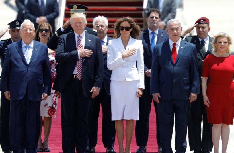 US President Donald Trump (2nd L) and first lady Melania Trump (3rd L) walk with Israeli Prime Minister Benjamin Netanyahu (2nd R), his wife Sara (R) and David Friedman (Center back), the new United States Ambassador to Israel, upon their arrival at Ben Gurion International Airport in Lod near Tel A (photo credit: REUTERS)