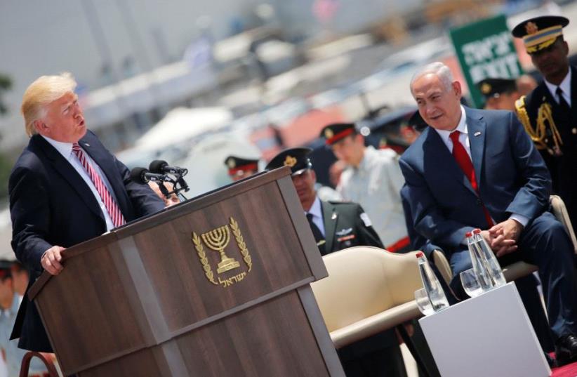 Prime Minister Benjamin Netanyahu (R) listens as U.S. President Donald Trump (L) speaks during a welcoming ceremony upon his arrival at Ben Gurion International Airport in Lod near Tel Aviv, Israel May 22, 2017 (photo credit: REUTERS)
