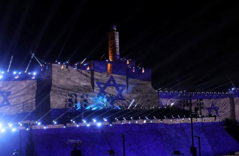 Israel's national flag is projected on the wall near the Tower of David in the Old City of Jerusalem May 20, 2017 (photo credit: RONEN ZVULUN/REUTERS)