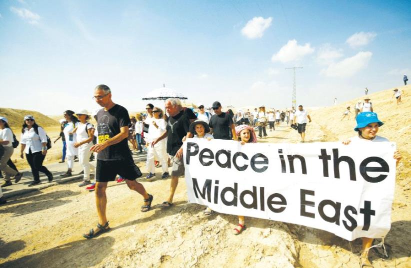 Demonstrators including Israeli and Palestinian activists take part in a demonstration in support of peace near Jericho last year (photo credit: REUTERS)