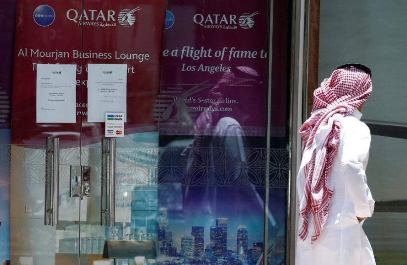 A man walks past Qatar Airways office in Riyadh, Saudi Arabia, June 5, 2017 (photo credit: REUTERS)