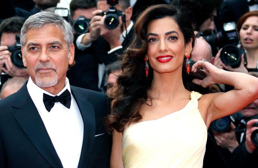 George and Amal Clooney at the 69th Cannes Film Festival in Cannes, France in 2016 (photo credit: REUTERS)