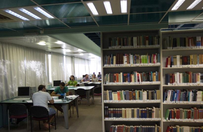 Students sit in a library at the Ariel University Center in the West Bank settlement of Ariel (photo credit: REUTERS/Ronen Zvulun)
