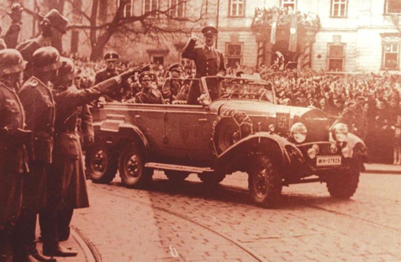 Adolf Hitler waves to crowds in his six-seater Mercedes car in this undated World War II file photo (photo credit: REUTERS)