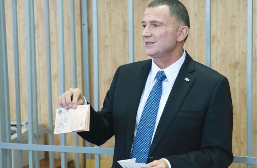 KNESSET SPEAKER Yuli Eldelstein holds his birth certificate and a union membership card, which were seized from him when he was jailed as a Prisoner of Zion 33 years ago (photo credit: ISRAELI EMBASSY MOSCOW)