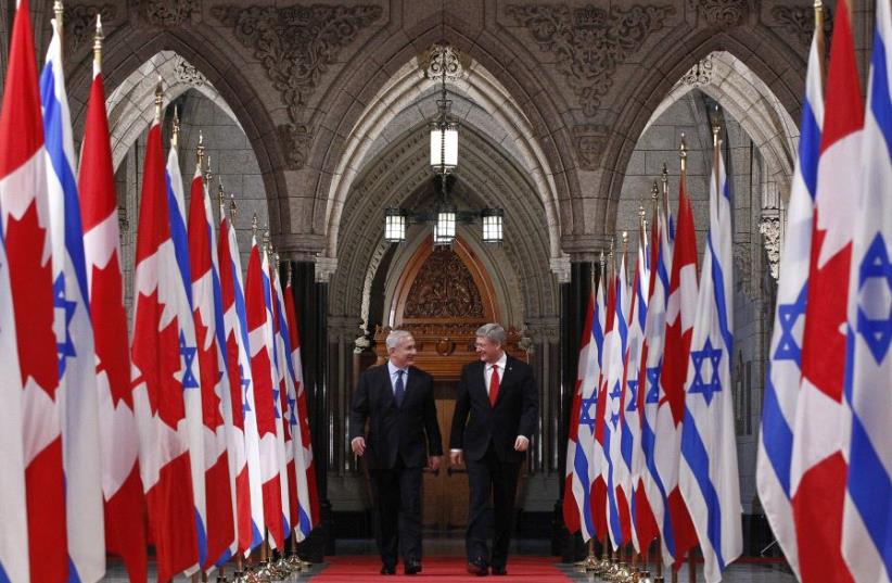 Canada's Prime Minister Stephen Harper (R) walks down the Hall of Honour with Israel's Prime Minister Benjamin Netanyahu on Parliament Hill in Ottawa March 2, 2012.  (photo credit: REUTERS/CHRIS WATTIE)
