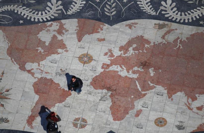 A tile design with the map of the world (photo credit: REUTERS)