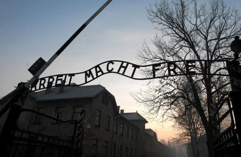 The Nazi slogan "Arbeit macht frei" (Work sets you free) is pictured at the gates of the former Nazi German concentration and extermination camp Auschwitz-Birkenau in Oswiecim, Poland January 27, 2017 (photo credit: AGENCY GAZETA/KUBA OCIEPA/VIA REUTERS)