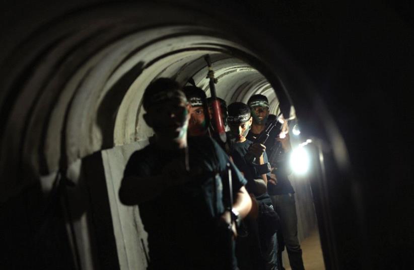 Young Palestinians advance through a tunnel during a military exercise organized by Hamas, east of Gaza City, last year (photo credit: REUTERS)