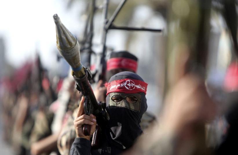 Palestinian members of the Popular Front for the Liberation of Palestine (PFLP) take part in a military show in Gaza  (photo credit: REUTERS)