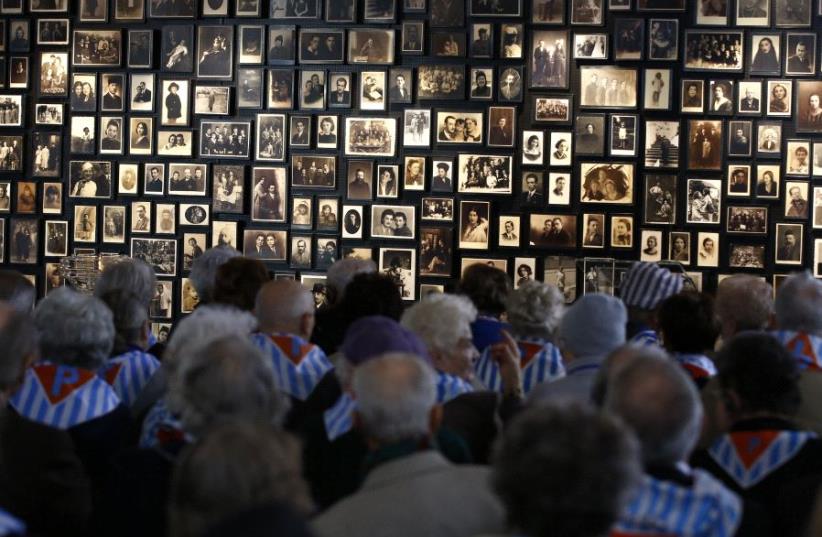 Survivors attend a ceremony in the former Nazi German concentration and extermination camp Auschwitz-Birkenau in Oswiecim, Poland January 27, 2016, to mark the 71st anniversary of the liberation of the camp by Soviet troops and to remember the victims of the Holocaust (photo credit: REUTERS)
