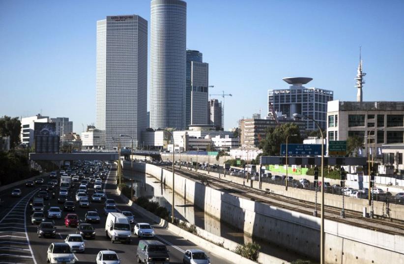 Vehicles drive on a highway in the central Israeli city of Tel Aviv December 17, 2013.  (photo credit: REUTERS)