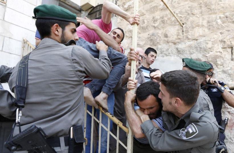 IDF Police detain Palestinians in Hebron (photo credit: REUTERS)
