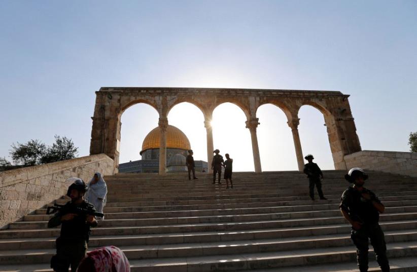 Israeli security forces stand at the compound known to Muslims as Noble Sanctuary and to Jews as Temple Mount, after Israel removed all security measures it had installed at the compound, and Palestinians entered the compound in Jerusalem's Old City July 27, 2017. (photo credit: REUTERS)
