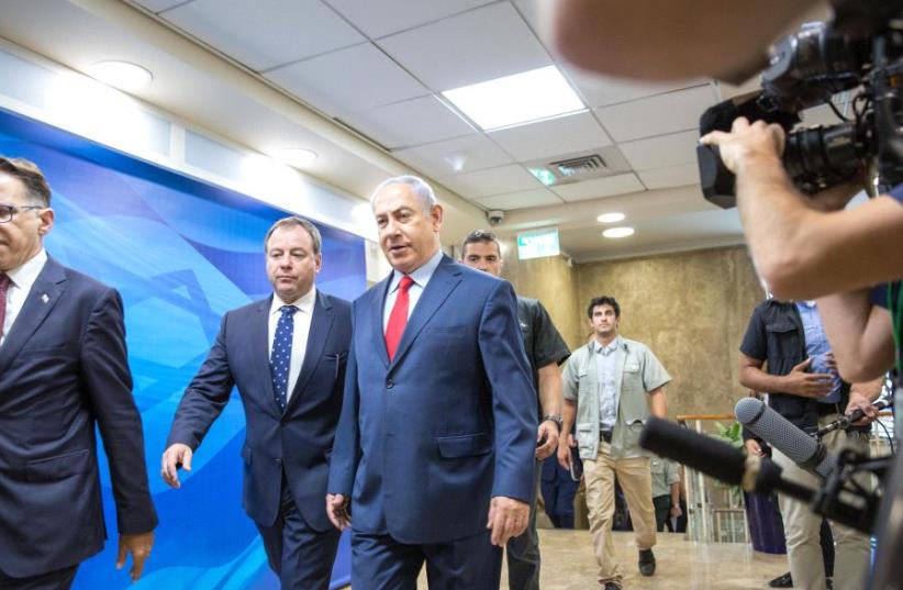 Prime Minister Benjamin Netanyahu enters a security cabinet meeting, August 2017 (photo credit: MARC ISRAEL SELLEM/THE JERUSALEM POST)