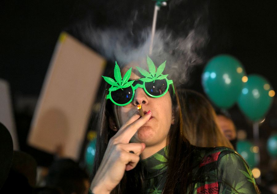 A woman smokes during an event marking Israel's government's approval of a new policy to decriminalize personal marijuana use in Tel Aviv, Israel February 4, 2017