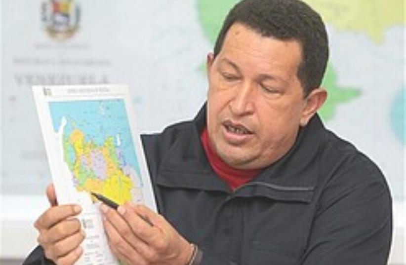 Chavez points to a map of the Venezuelan-Colombian (photo credit: AP)
