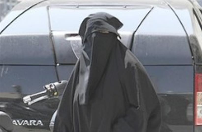 A woman wearing the niqab, a veil worn by the most conservative Muslims that exposes only a woman's eyes, walking in Marseille. (photo credit: AP)