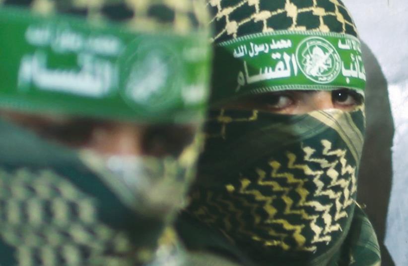 Hamas members are seen close up during a press conference in the Gaza Strip last week. (photo credit: REUTERS)