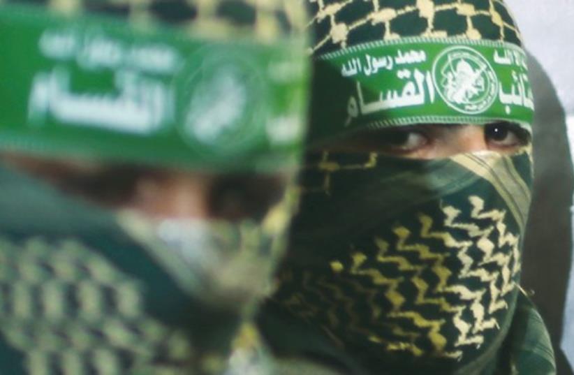 Hamas members are seen close up during a press conference in the Gaza Strip last week. (photo credit: REUTERS)