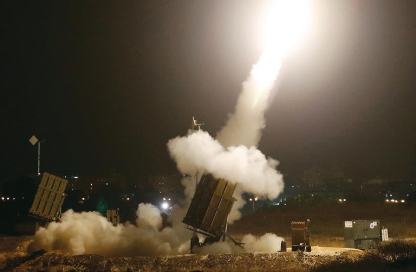 An iron dome launches rockets to intercept incoming rockets from Gaza on Tuesday. (photo credit: REUTERS)