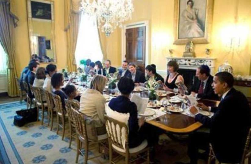 US President Barack Obama and Michelle Obama host a Passover seder dinner with friends and staff at the White House, April 2009 (photo credit: REUTERS/PETE SOUZA/THE WHITE HOUSE/HANDOUT)