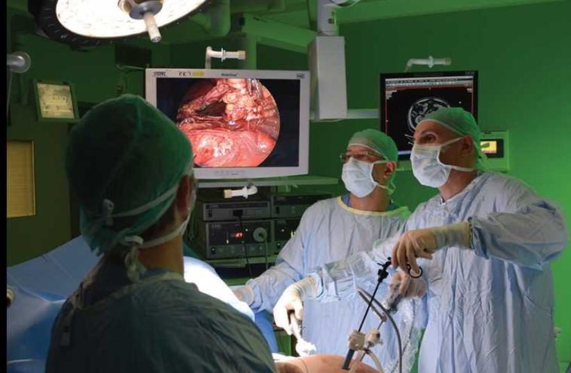 Doctors perform surgery (photo credit: COURTESY SZMC)