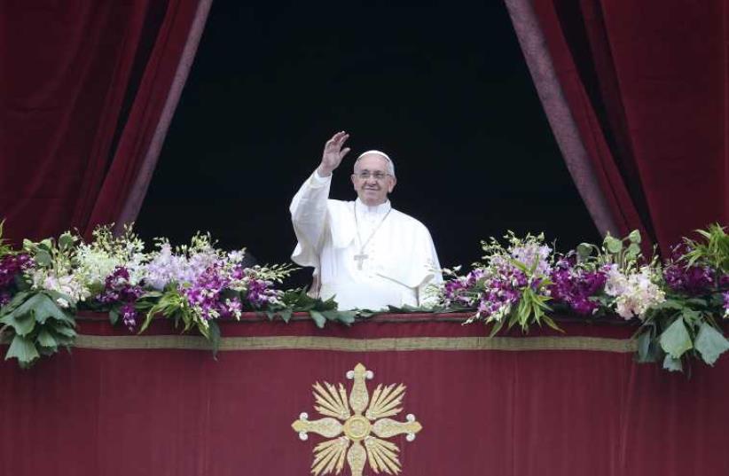 Pope Francis waves as he delivers a "Urbi et Orbi" message at the Vatican April 5, 2015 (photo credit: REUTERS)