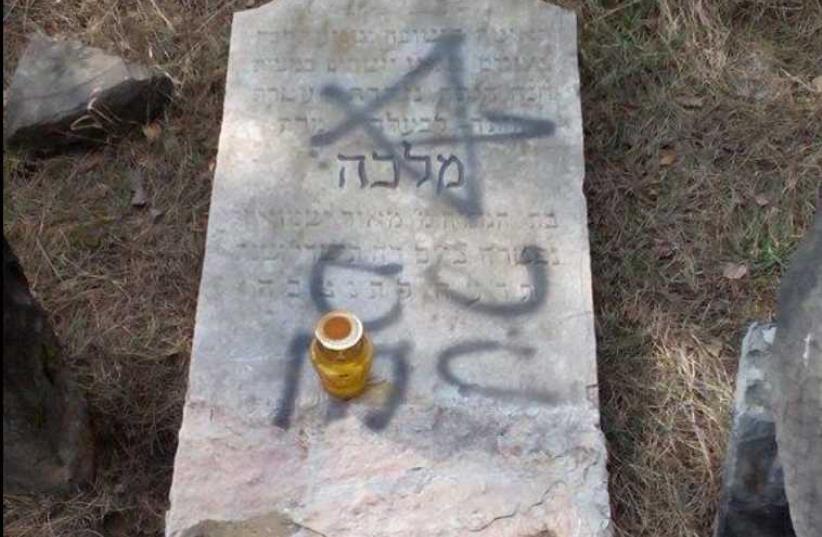 A Jewish gravestone defaced in the town of Olkusz, Poland (photo credit: MONITORING CENTRE FOR RACIST AND XENOPHOBIC BEHAVIOR)