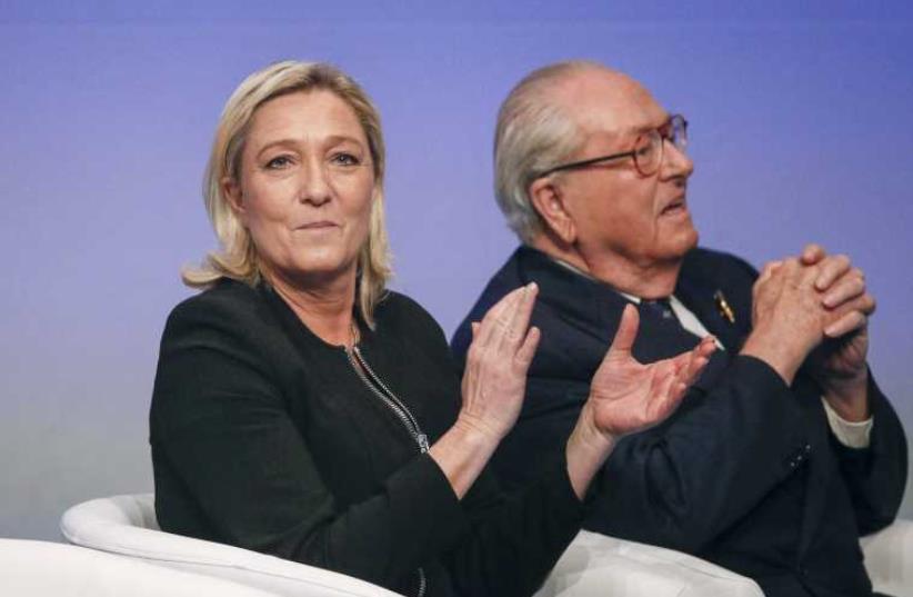 Marine Le Pen (L), France's National Front political party leader, sits next to her father Jean-Marie Le Pen [File] (photo credit: REUTERS)