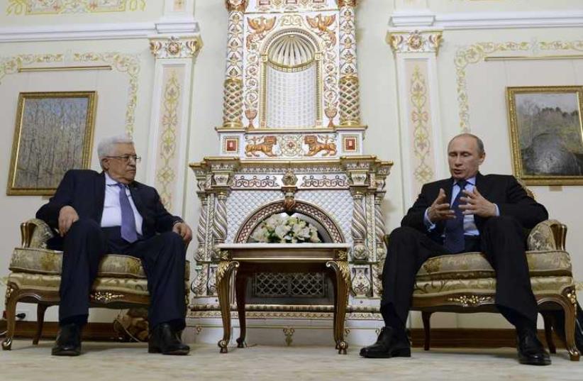 Russia's President Vladimir Putin speaks with Palestinian Authority President Mahmoud Abbas during their meeting at the Novo-Ogaryovo state residence outside Moscow June 25, 2014 (photo credit: REUTERS)