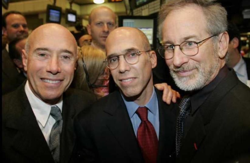 David Geffen (L), Jeffrey Katzenberg (C), and Steven Spielberg (R), pose on the floor of the New York Stock Exchange (photo credit: REUTERS)
