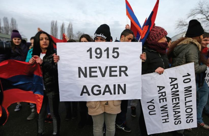 An Armenian protester holds a banner reading ‘1915 never again’ as she takes part in a demonstration near the European Court of Human Rights in Strasbourg in January (photo credit: REUTERS)
