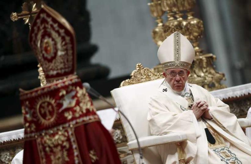 Pope Francis listens as the Patriarch of the Armenian Catholic Church Nerses Bedros XIX Tarmouni speaks during a mass on the 100th anniversary of the Armenian mass killings in St. Peter's Basilica at the Vatican April 12, 2015. (photo credit: REUTERS)