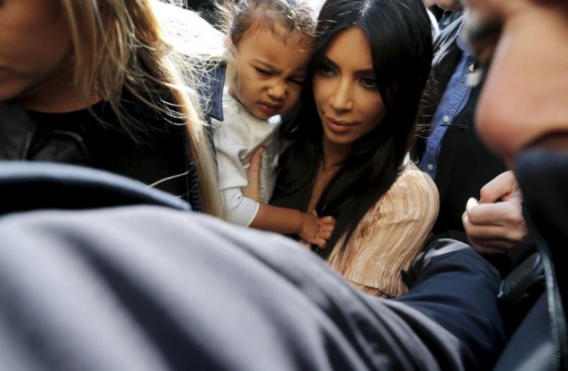 Kim Kardashian and daughter North West arrive for a baptism ceremony at the Cathedral of Saint James in Jerusalem's Old City (photo credit: REUTERS)