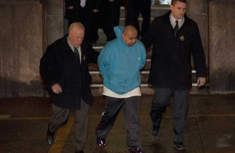 New York City police officers escort accused hit-and-run driver Julio Acevedo (C) as they leave a New York Police Precinct to Kings County Criminal Court in Brooklyn, New York March 7, 2013.  (photo credit: REUTERS)