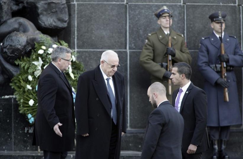 President Reuven Rivlin attends a wreath laying ceremony at the Monument of the Heroes of the Ghetto in Warsaw, October 2014 (photo credit: REUTERS)