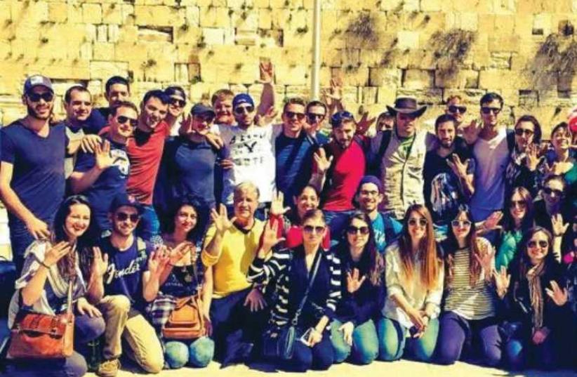 The writer's Taglit-Birthright group at the Western Wall giving a dedication with the Vulcan salute to Leonard Nimoy, who died in February. (photo credit: Courtesy)