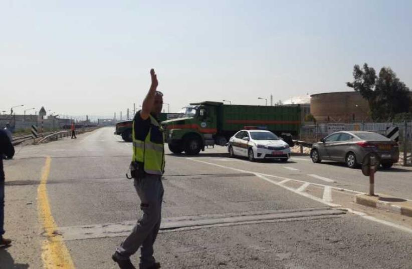 Municipal trucks block entrance to factories linked to air pollution.  (photo credit: Courtesy)