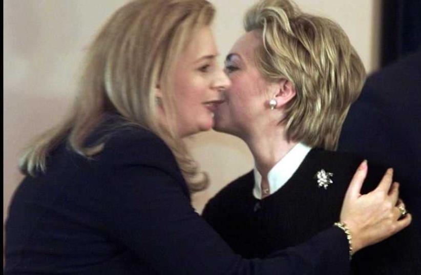 Then-first lady Hillary Rodham Clinton (R) and kisses Suha Arafat, wife of the late Palestinian leader Yasser Arafat, November 11, 1999 (photo credit: REUTERS)