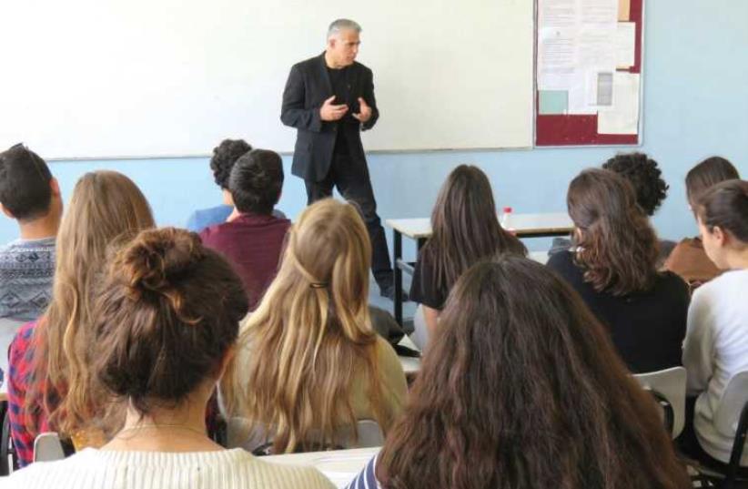 MK Yair Lapid talks to high-school students in Tel Aviv about his father’s Shoah experiences on the eve of Holocaust Remembrance Day. (photo credit: Courtesy)