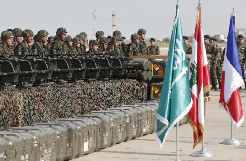 Lebanese army soldiers stand next to displayed weapons that they received during a ceremony at Beirut airport airbase April 20 (photo credit: REUTERS)