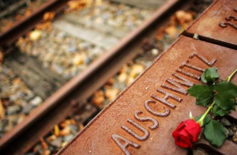 A red rose lies at Gleis 17 (platform 17) holocaust memorial at a former cargo railway station in Berlin-Grunewald (photo credit: REUTERS)