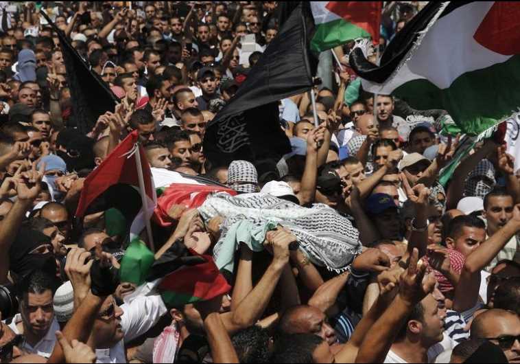 Palestinians carry the body of 16-year-old Muhammad Abu Khdeir during his funeral in Shuafat (credit: Reuters)