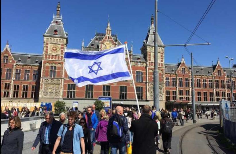 A fellow church member walking through Amsterdam with the Israeli flag (photo credit: Courtesy)